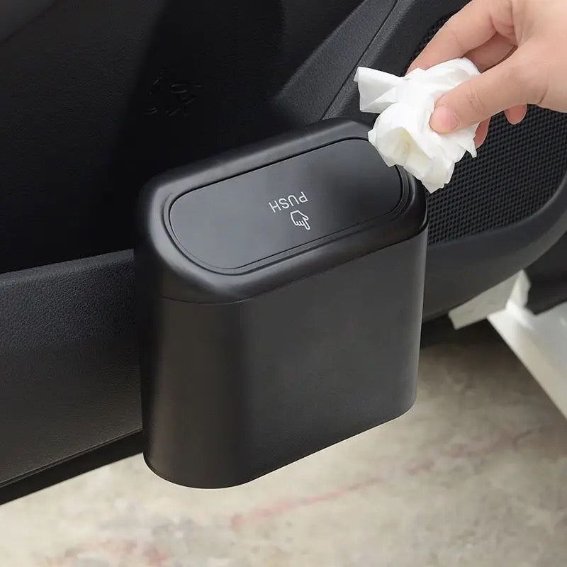 A person putting trash in Hanging Vehicle Garbage Storage Box