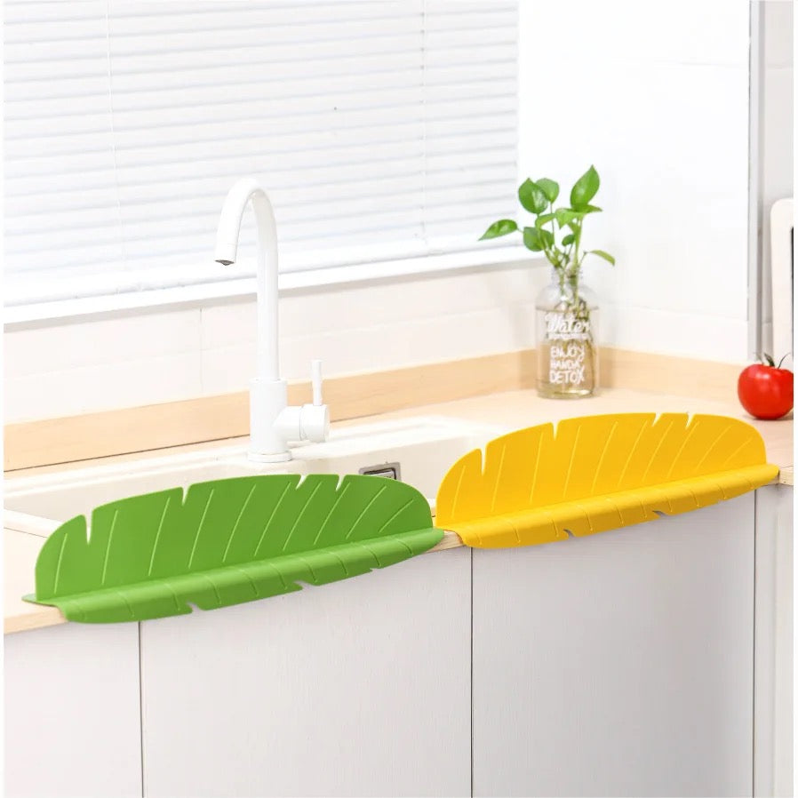 Yellow and Green color Kitchen Sink Splash Guard installed on a sink  