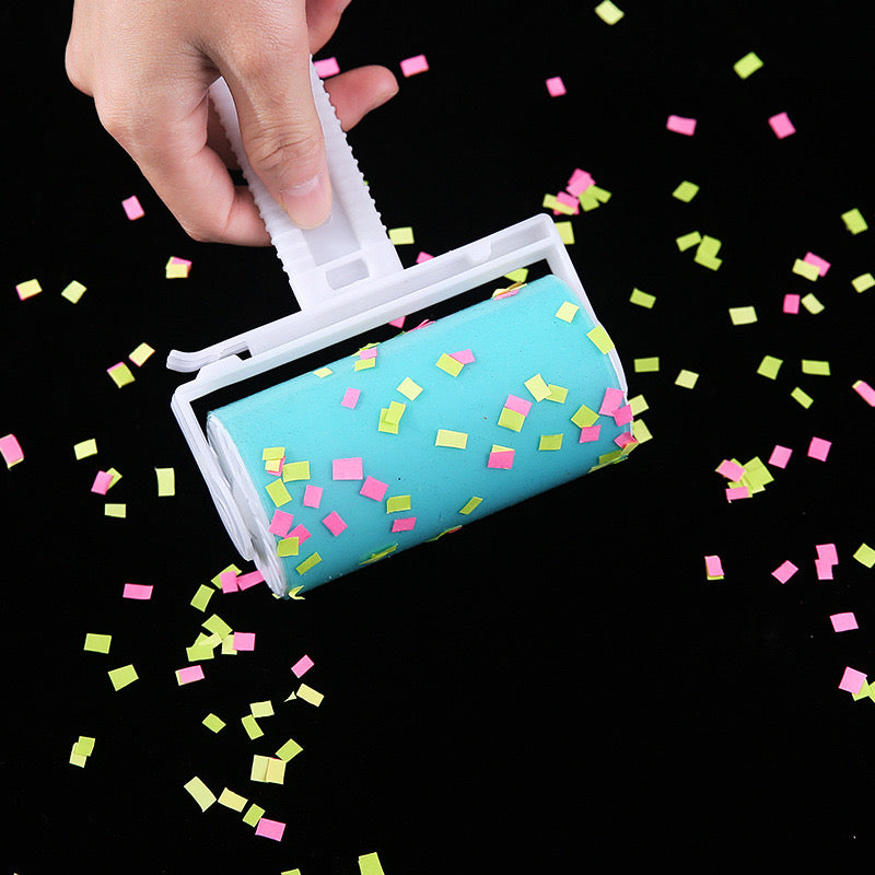 A person rolls confetti using a reusable lint remover