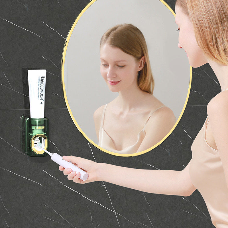 A lady extracting toothpaste from Wall-Mounted Toothpaste Dispenser and Squeezer mounted next to a mirror 