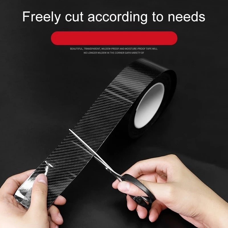 A person cutting of a part from Anti-Scratch 5D Carbon Fiber Stickers using a siccor