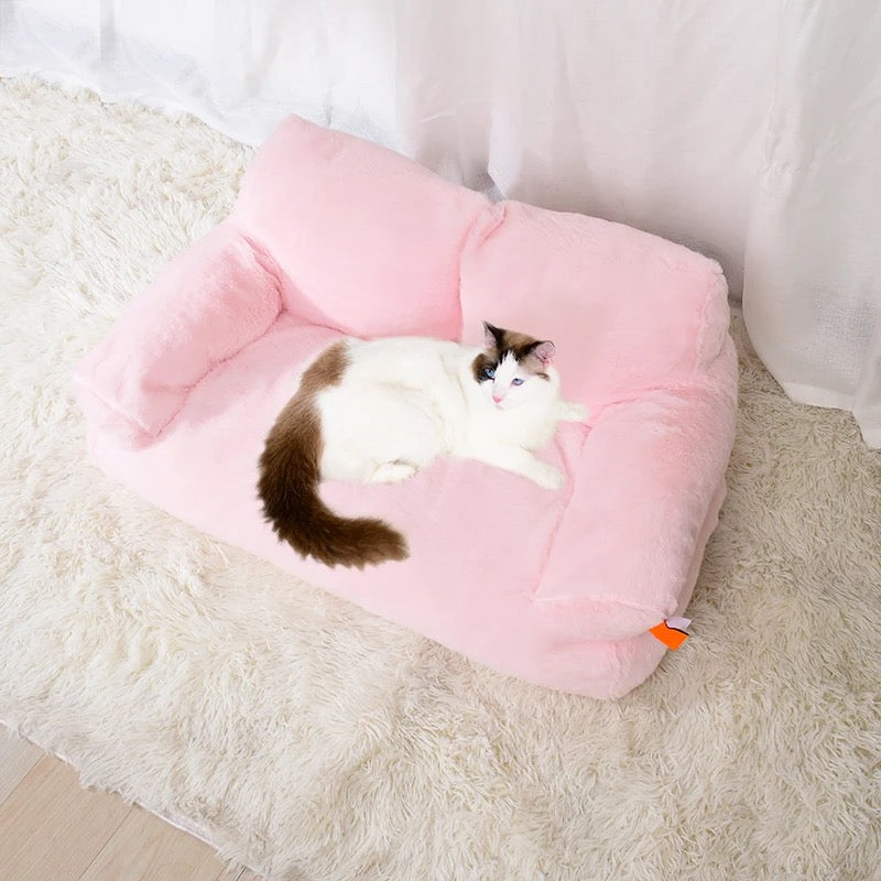 A cat lying on a pink color Cat Sofa Couch Cushion 