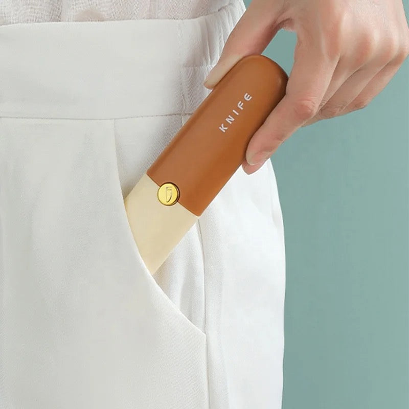 A person pulling out 2 in 1 Knife and Peeler from pants pocket 