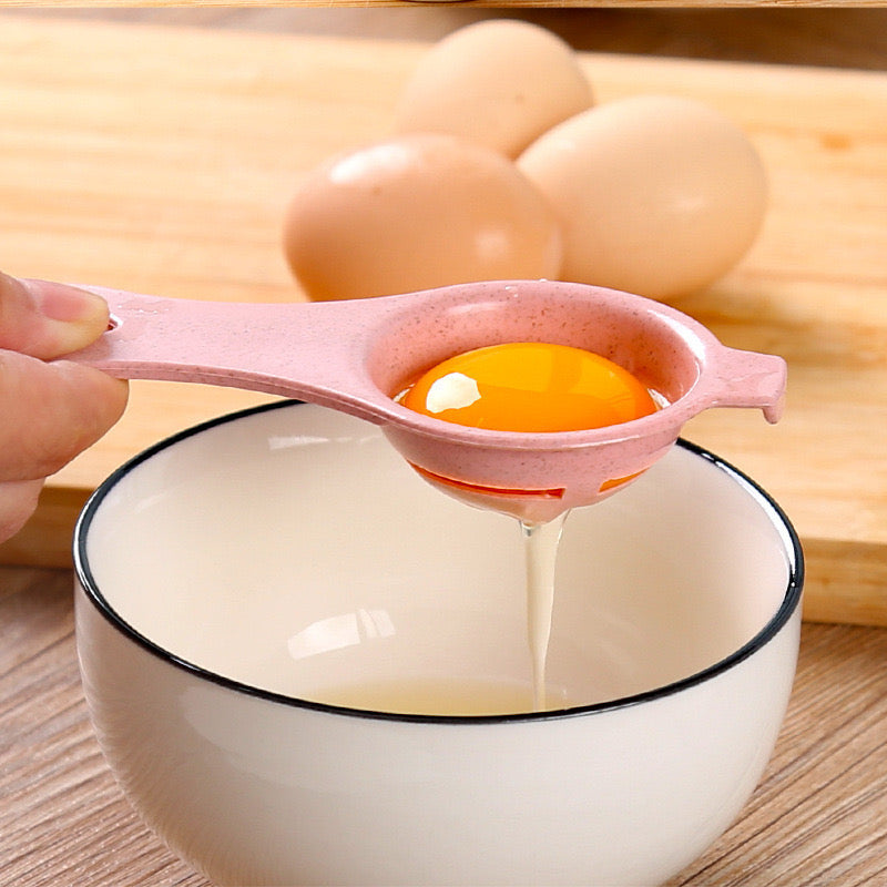 A person separating egg yolk to a bowl using Egg Separator Tool
