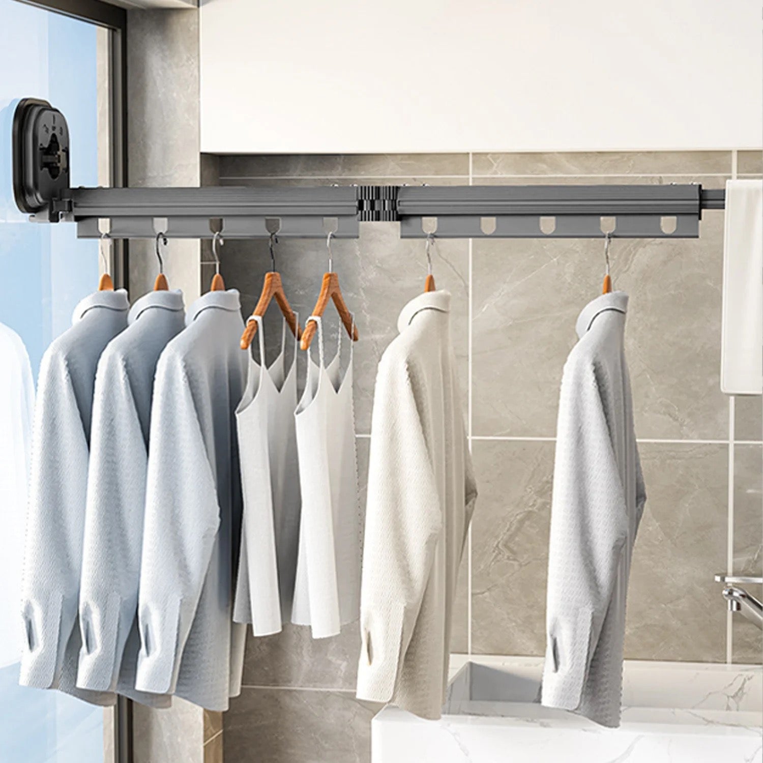 Clothes Drying Rack mounted on a glass and left unfolded with cloths hung 