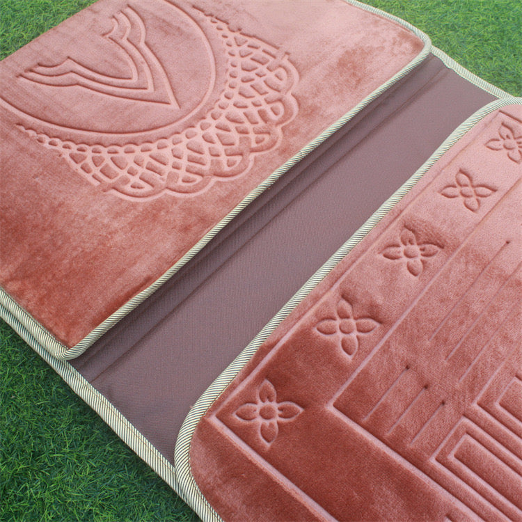 2 sides of Red color Islamic Foldable Prayer Mat folded and kept on grass  
