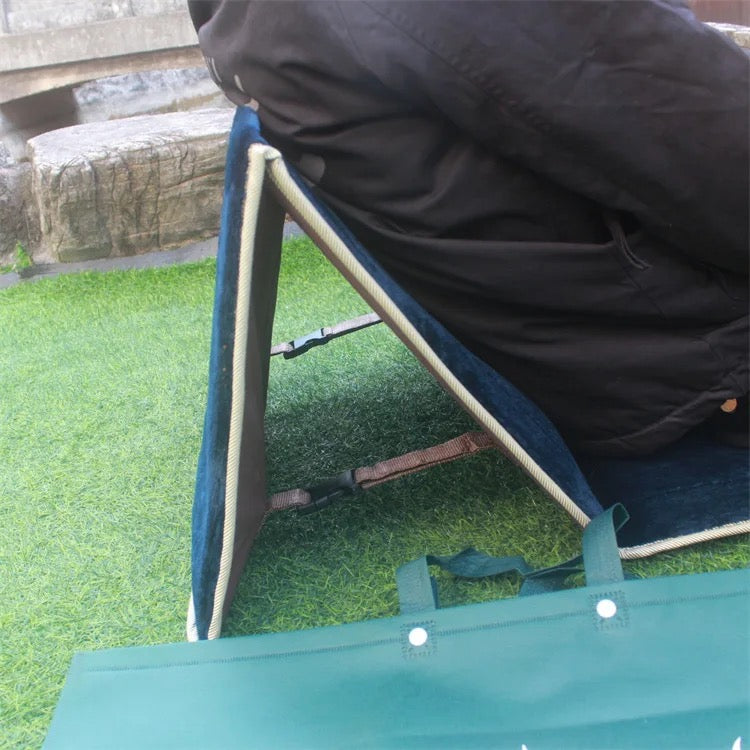 A person lying on the backrest of Islamic Foldable Prayer Mat 