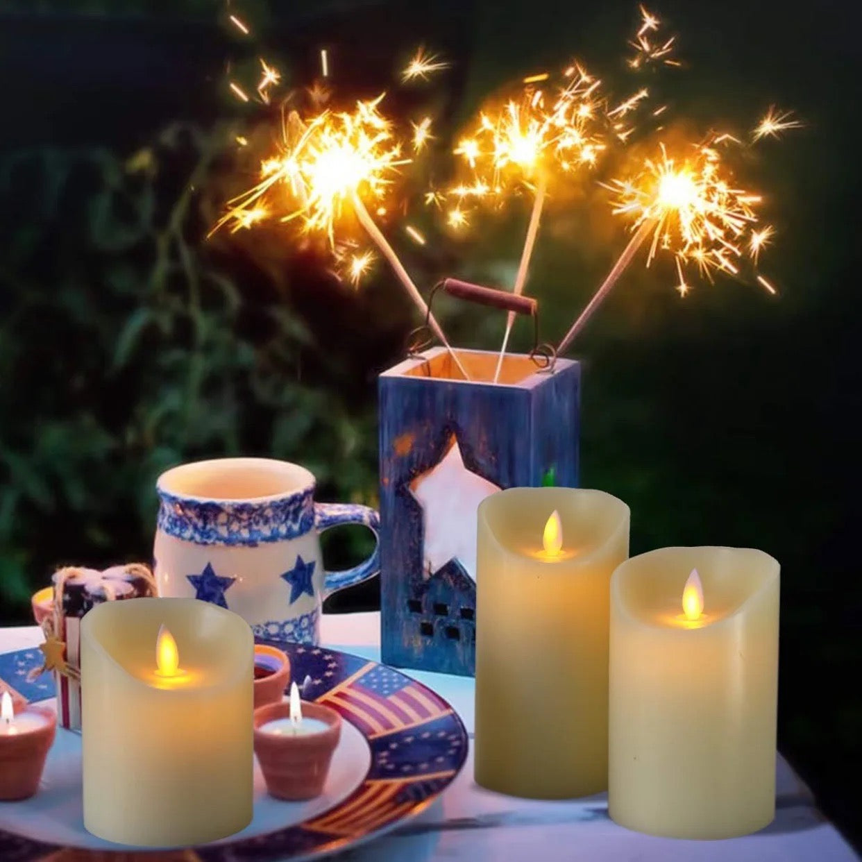 3 Flameless LED Candles in different sizes lit up and kept on a tea table along with utensils and sparklers