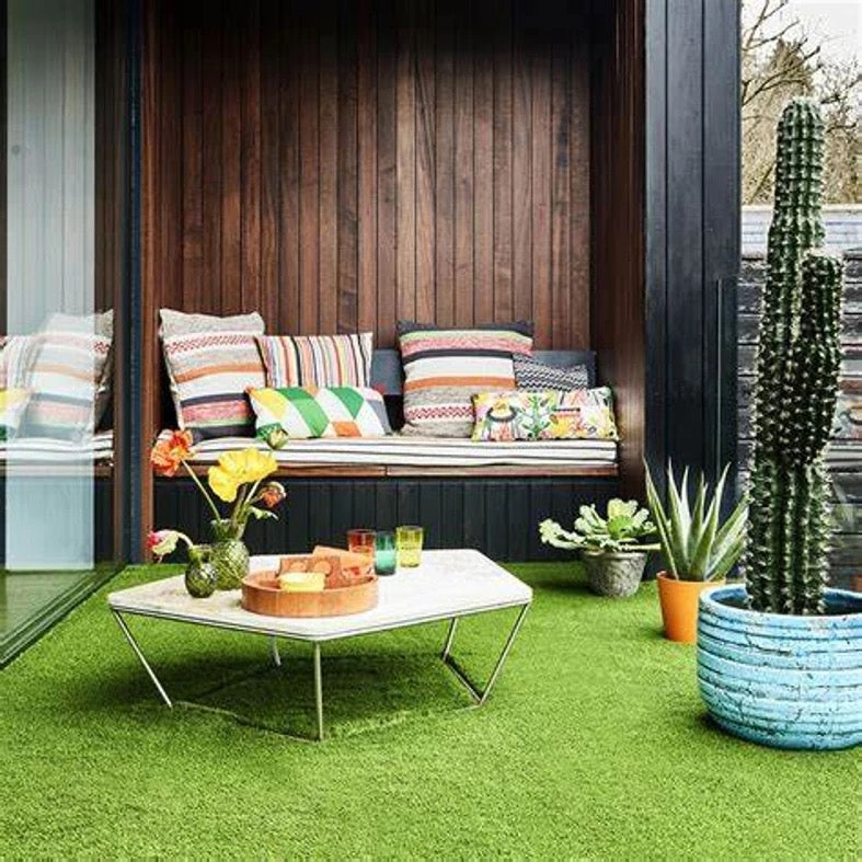 An open top living room of a house with Artificial Grass Carpet laid on the floor 