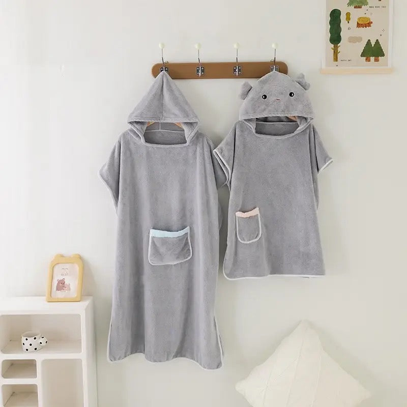 Adult and Children Quick-Drying Hooded Bathrobe hung on wall hook 