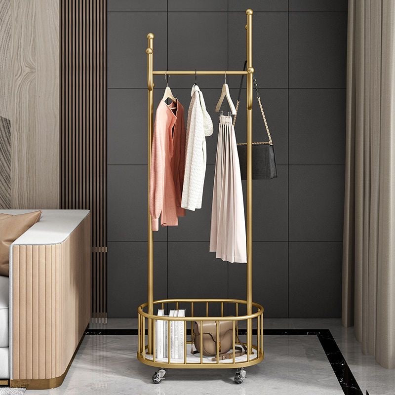 A Classic Minimalist Modern Metal Clothing Stand Wardrobe Garment Storage Rack with wheels is placed on the floor, adorned with dresses and bags
