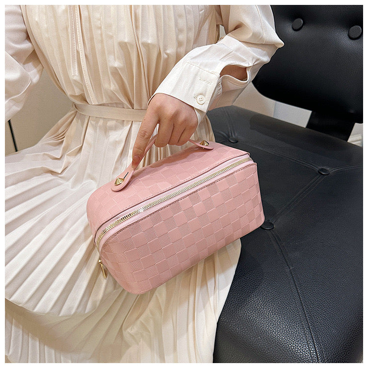 A lady holding Pink color Cosmetic Bag
