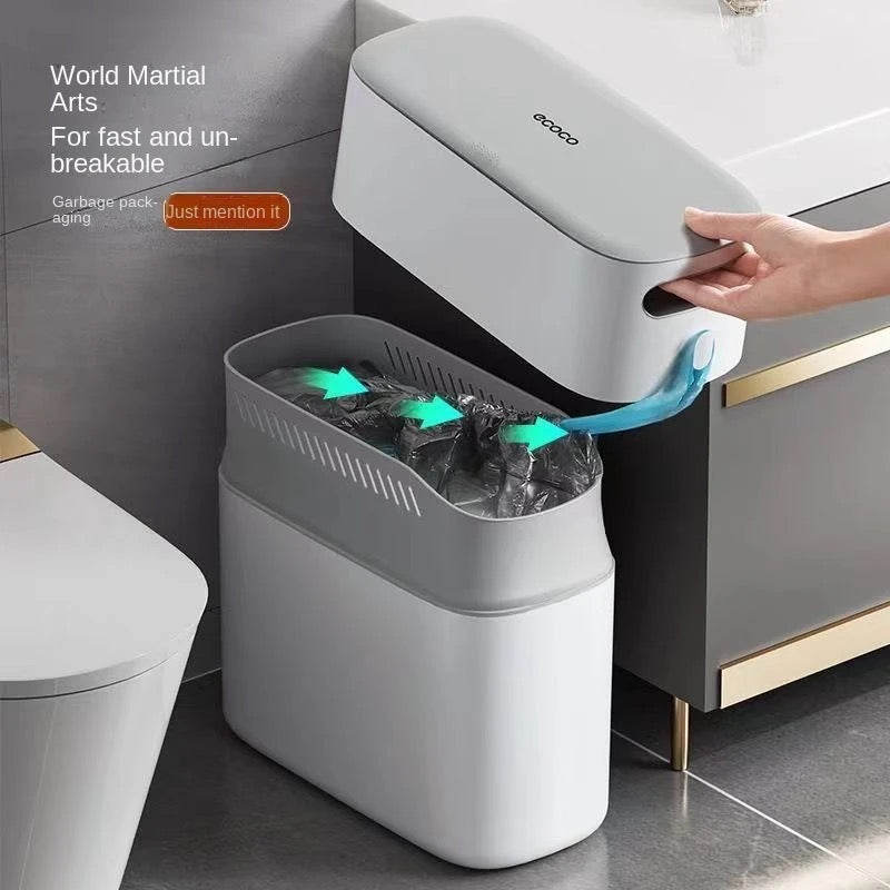 A person opening the lid of Press-type Trash Can situated in a narrow space of bathroom 