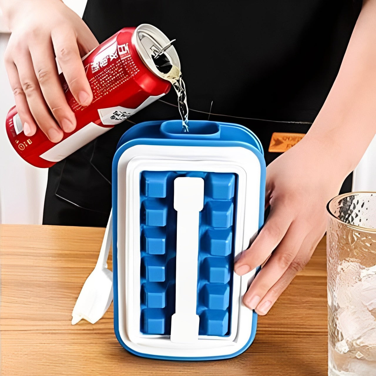 A Person is Filling Ice Cube Tray With Soft Drinks.