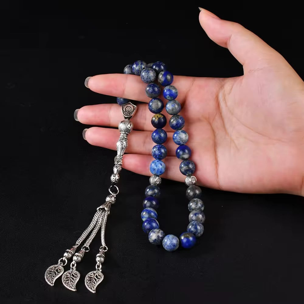 A Person is Holding an Islamic Tasbih Prayer Beads