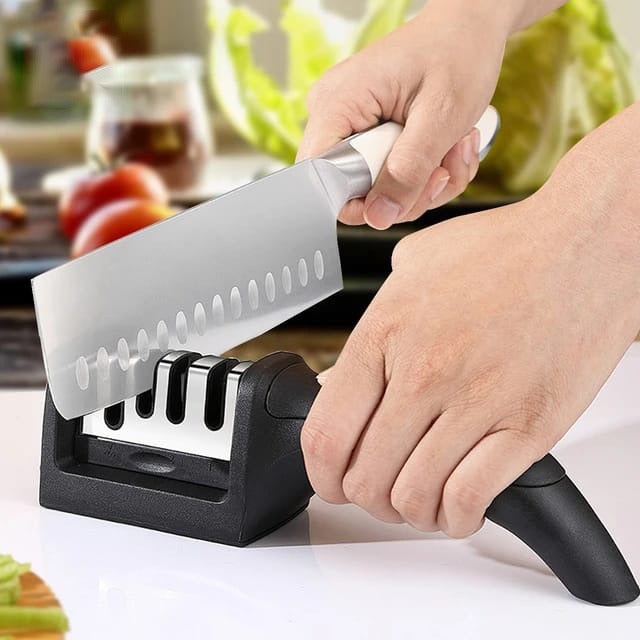 A Man is Sharpening Knife Using Kitchen Knife Sharpener.