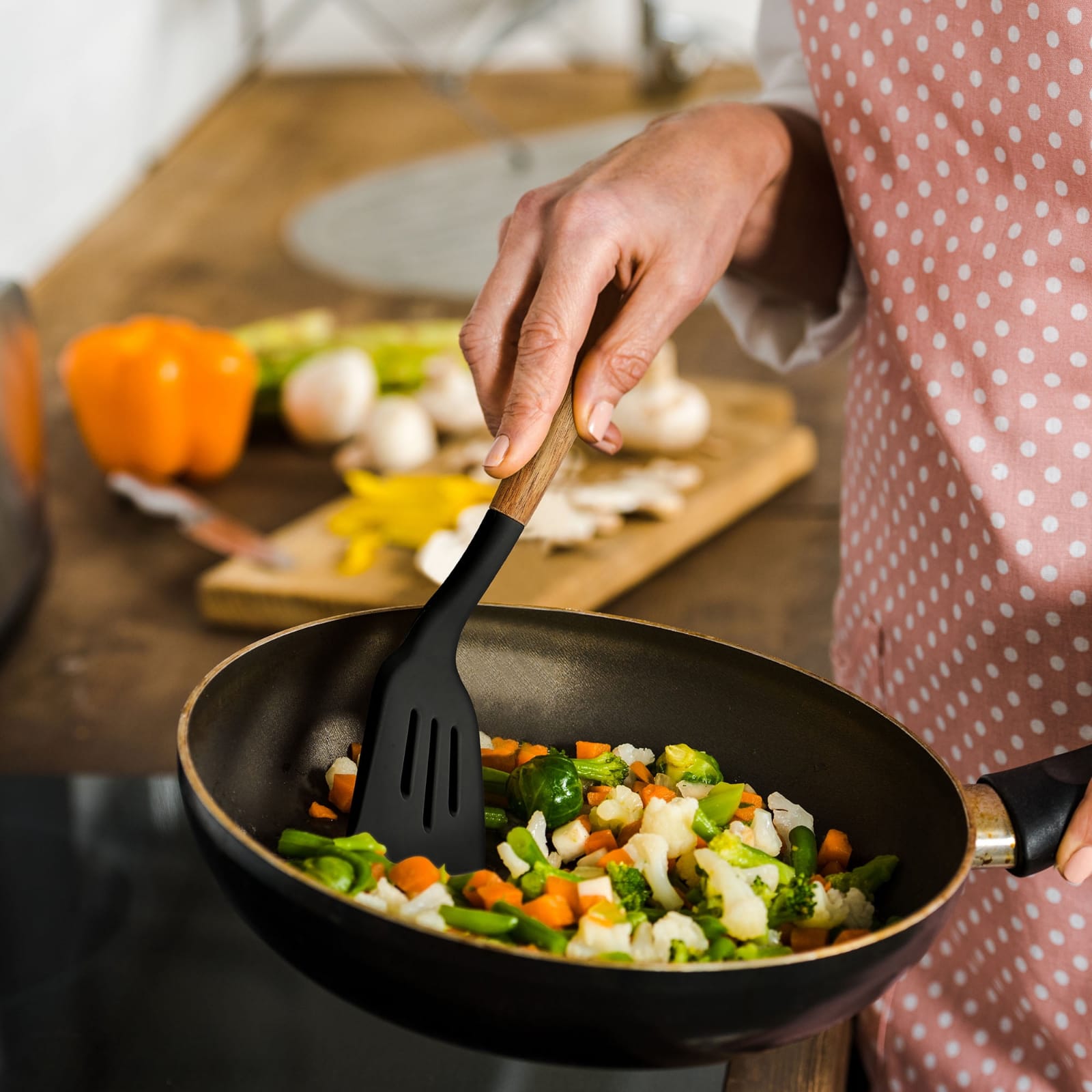 A Person is Using Spoon From Kitchen Spoon Utensil Set.