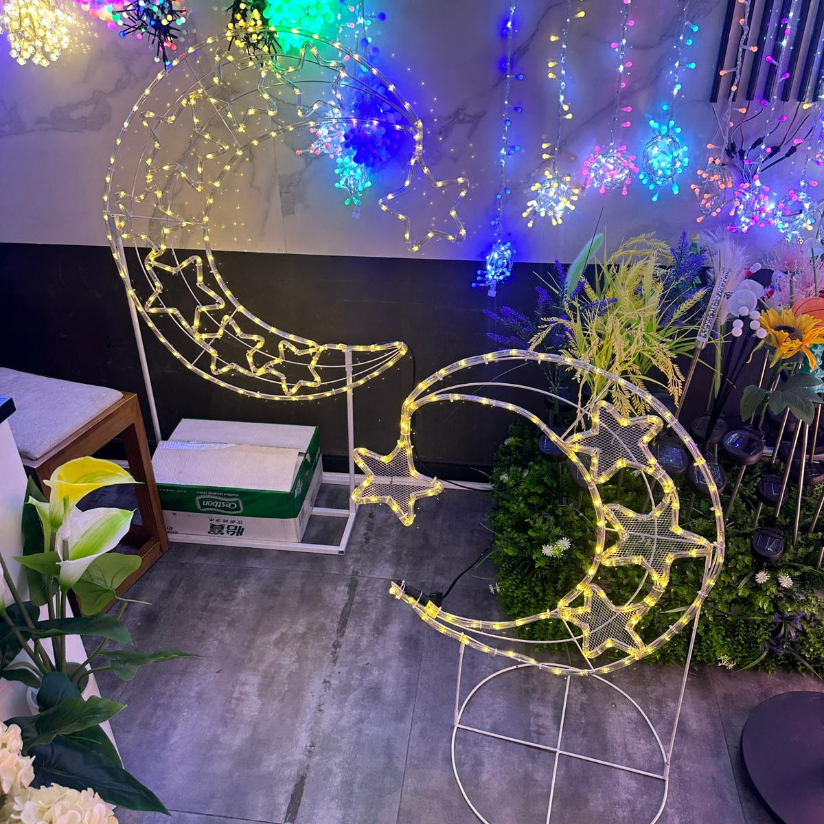 LED Moon & Star Floor Standing Lights are Placed at a Garden Area.