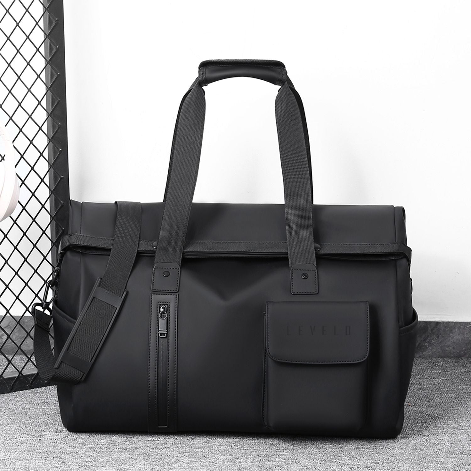 LEVELO Monaco Waterproof Travel Duffel Bag with a shoulder strap on a textured surface.