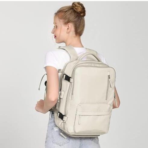 A Woman is Carrying a Large Capacity Travel Backpack.