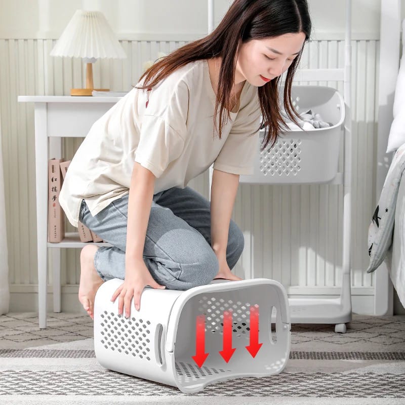 A Women is Testing The Flexibility Of Laundry Storage Basket With Hanger.