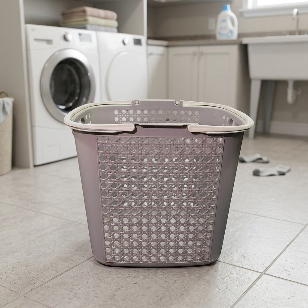 Gray laundry basket on a tiled floor in a laundry room with a washing machine in the background.