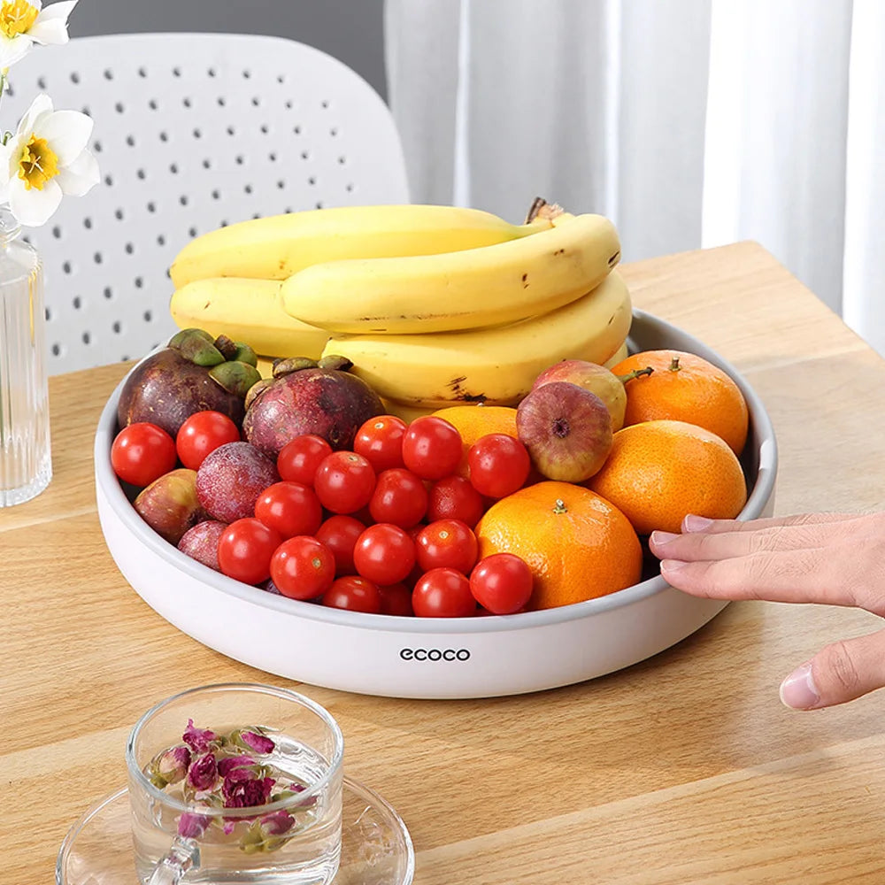 The Ecoco 360° Rotating Storage Tray with some items in it has been placed on the table