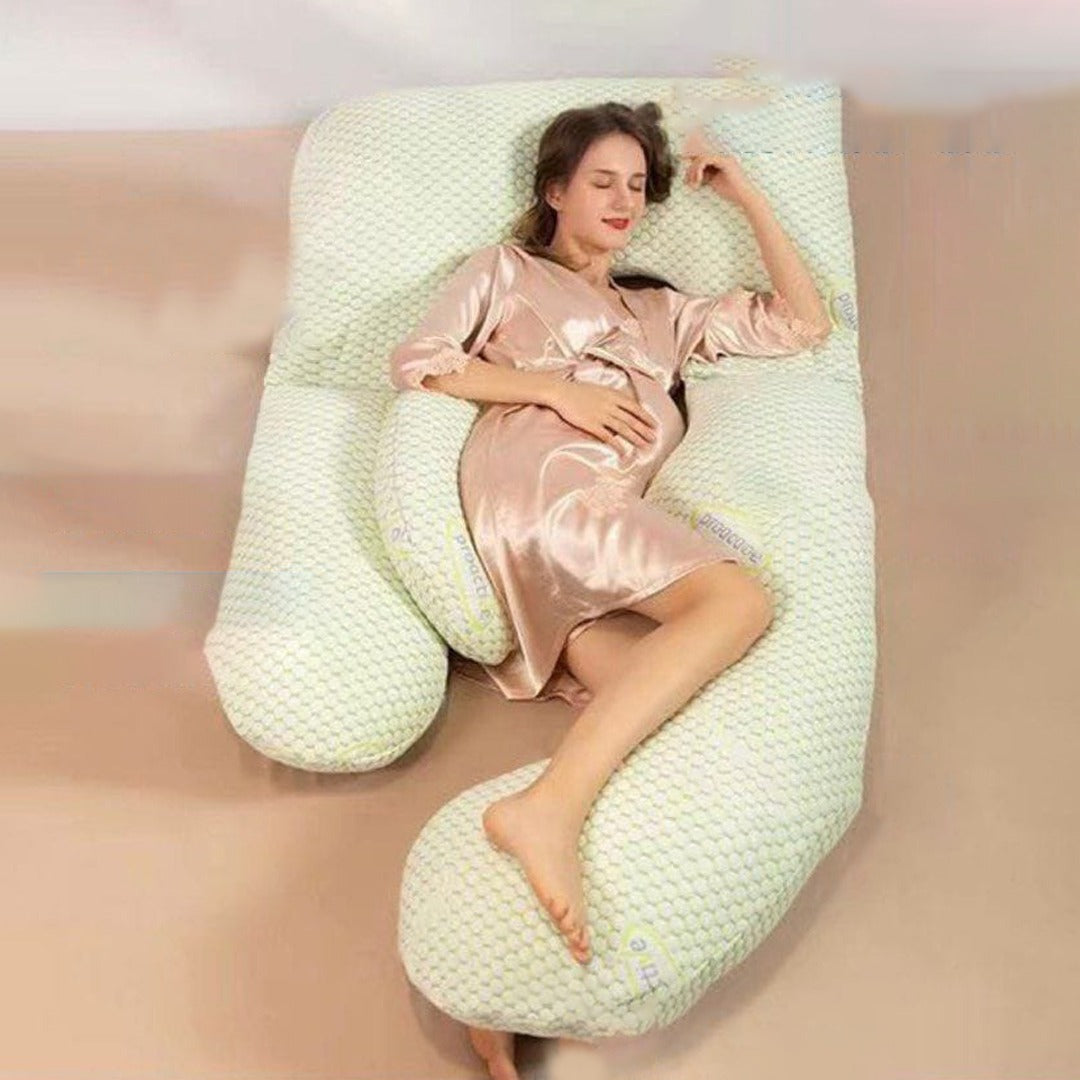 A Women is Lying On a Pregnancy Pillow.