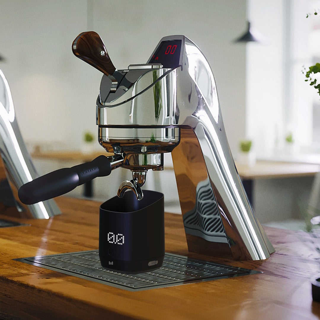 Espresso machine on a wooden table with a Macnoa MacScale Cup Digital Coffee Dosing Cup 