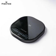 A sleek, Macnoa MacScale Pro Smart Coffee Scale with a glossy finish and an illuminated LCD display, shown on a clean white background with the 'macnoa' brand logo in the top-left corner.