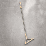 Magic Broom Floor Squeegee with a long handle and triangular head on a gray tiled floor