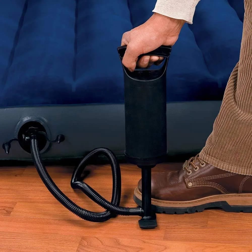 A Person is Pumping a Bed Using Manual Air Pump.