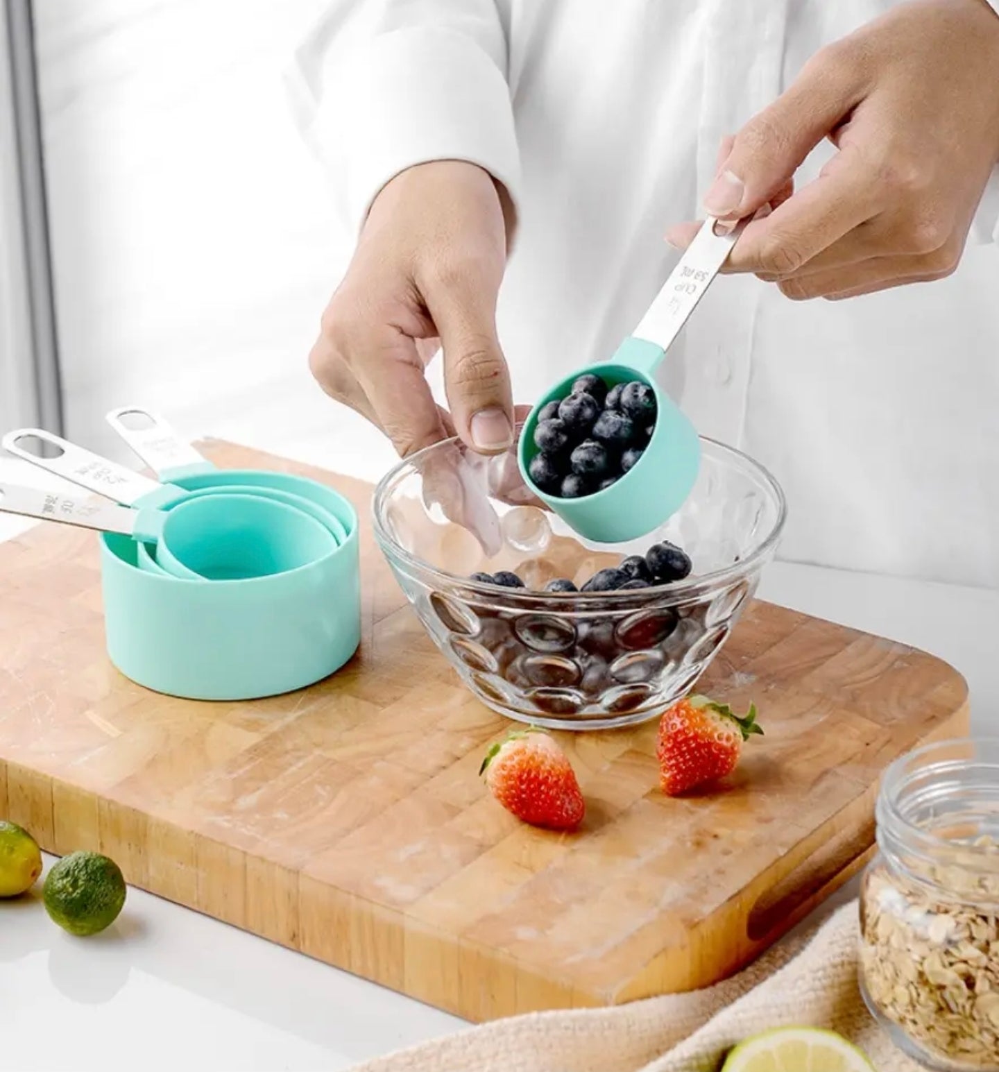 A Person is Measuring Blueberry Using Measuring Cups and Spoons Set.