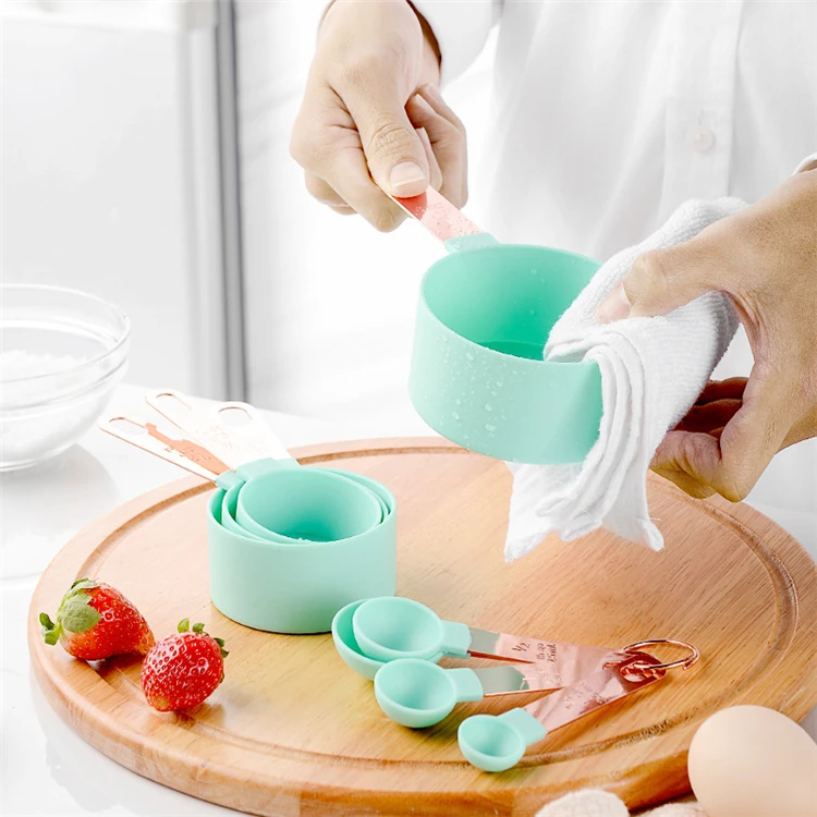 A Person Is Using Measuring Cups and Spoons Set