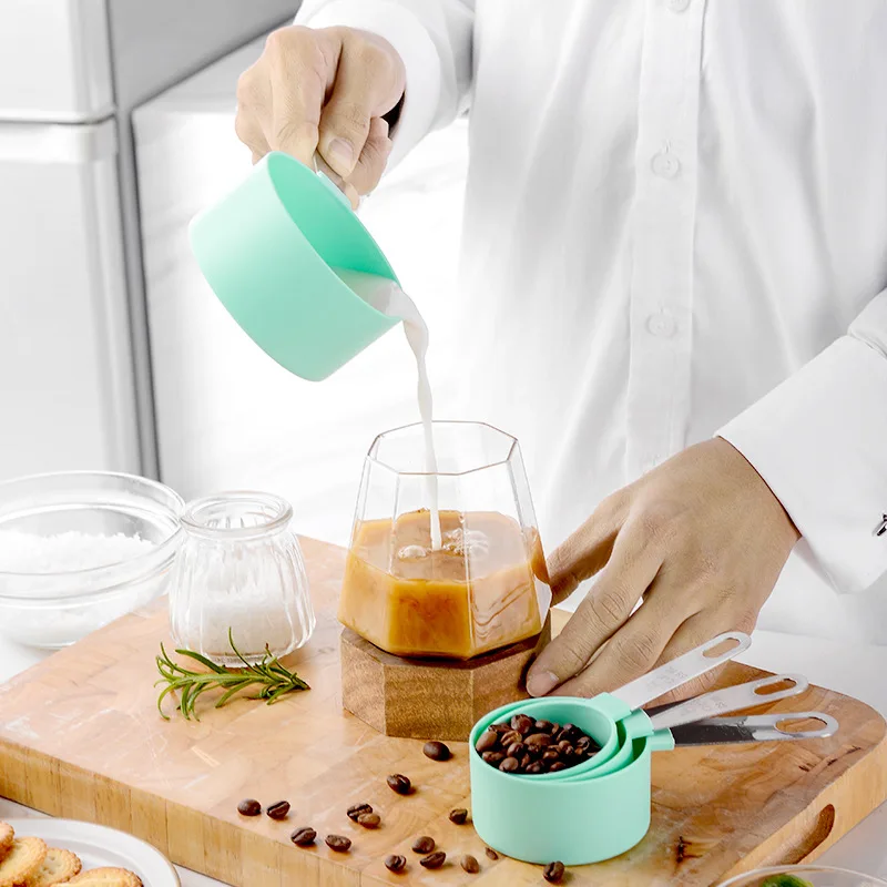 A Person is Measuring Milk Using Measuring Cups and Spoons Set.