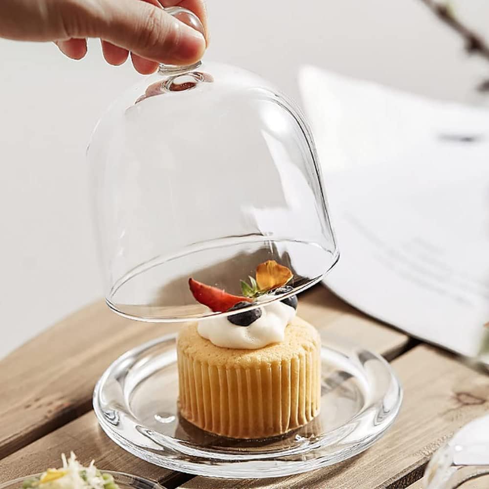 Someone is Holding the Lid Of Mini Glass Cake & Pastry Serving Dome.