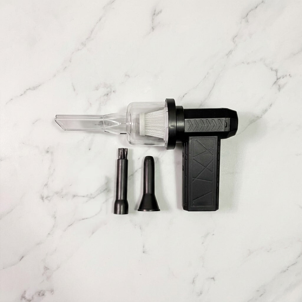 Mini Jet Fan Compressed Air Duster with attachments on a marble surface