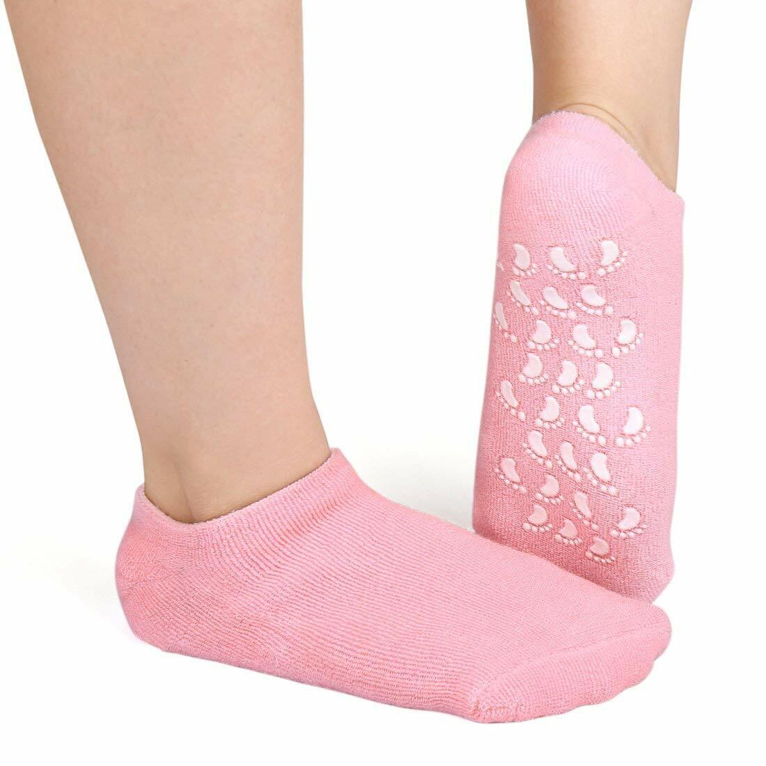 A person is wearing Pink Moisturizing Spa Gel Socks with cut-out design on a white background