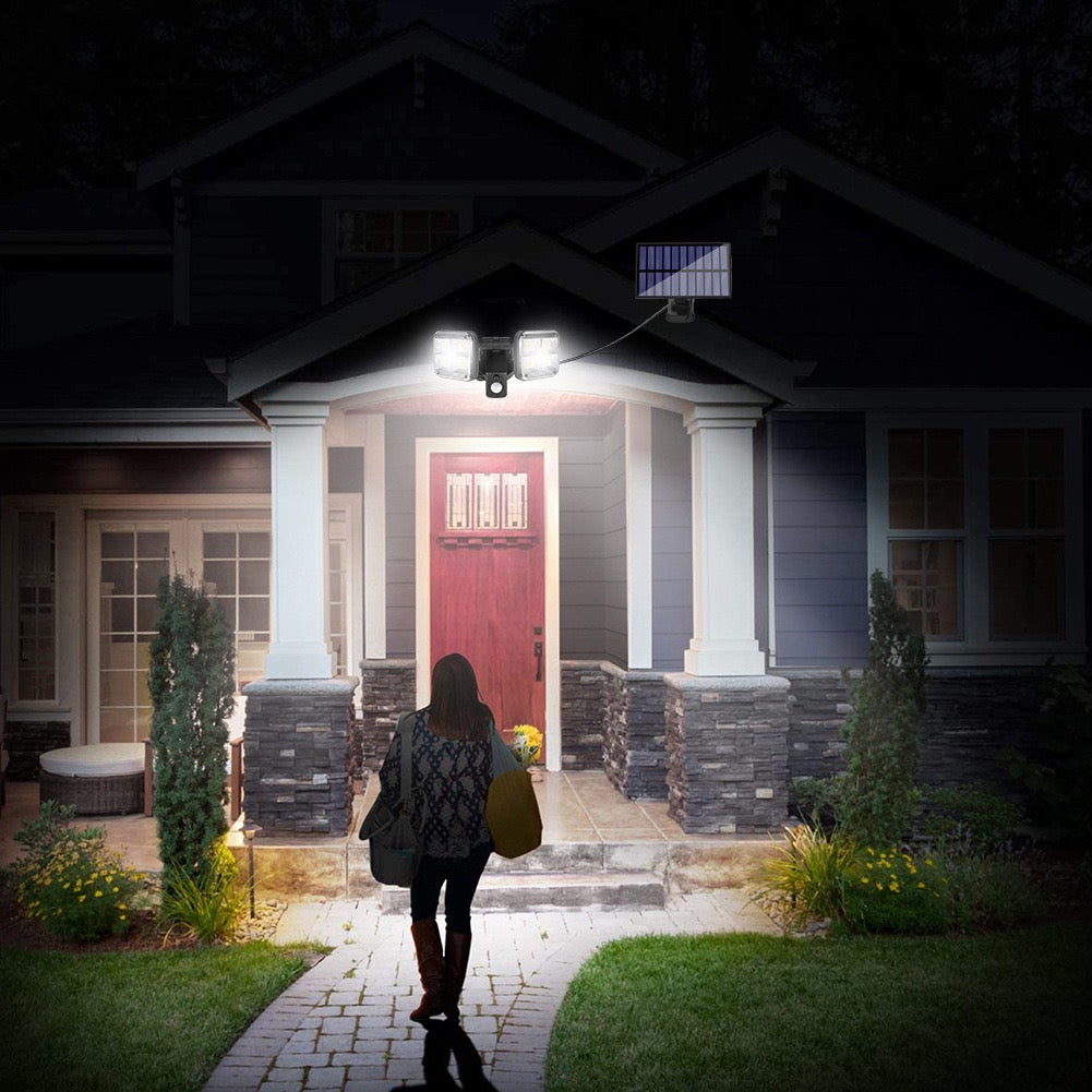  A person walking on a brick path to a house at night with the help of a motion sensor LED solar light