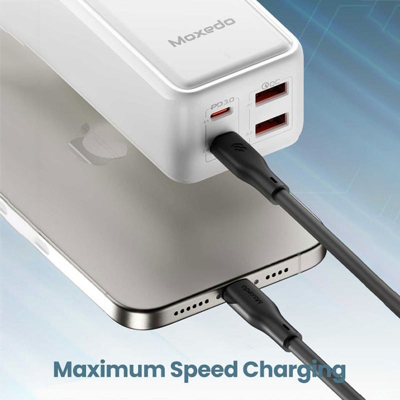 Moxedo Smart-Plug 65W GaN III Tech Extension Cord charging a smartphone with 'Maximum Speed Charging' text.