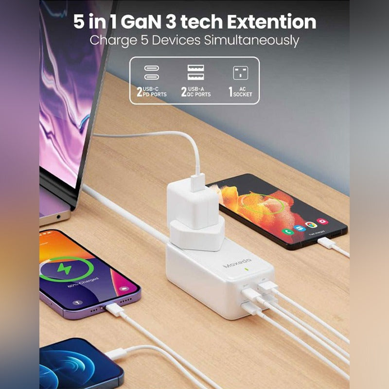 Moxedo Smart-Plug 65W GaN III Tech Extension Cord charging multiple devices on a wooden surface.