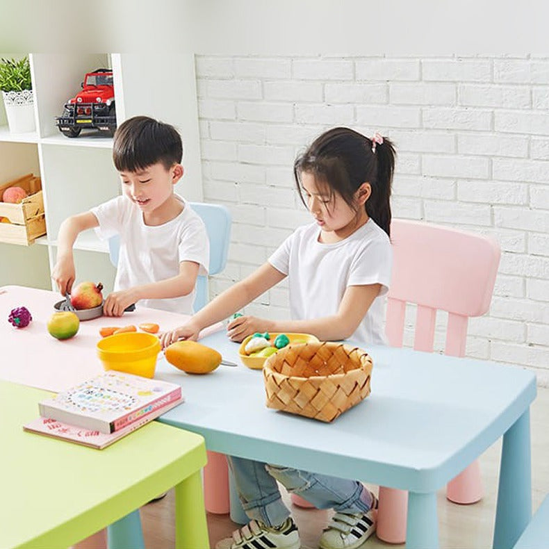 Two Children Slicing Fruits on a Multi-Purpose Kids Table and Chair Set.