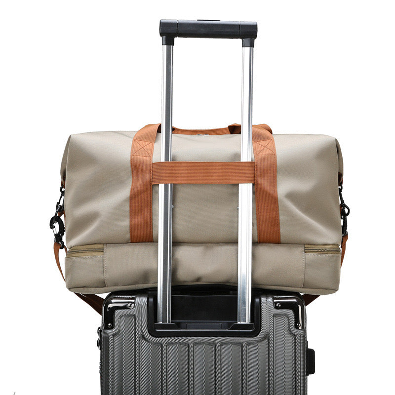 Multi-functional Fashion Fitness Travel Duffle Bag is Placed Above Trolley Bag.