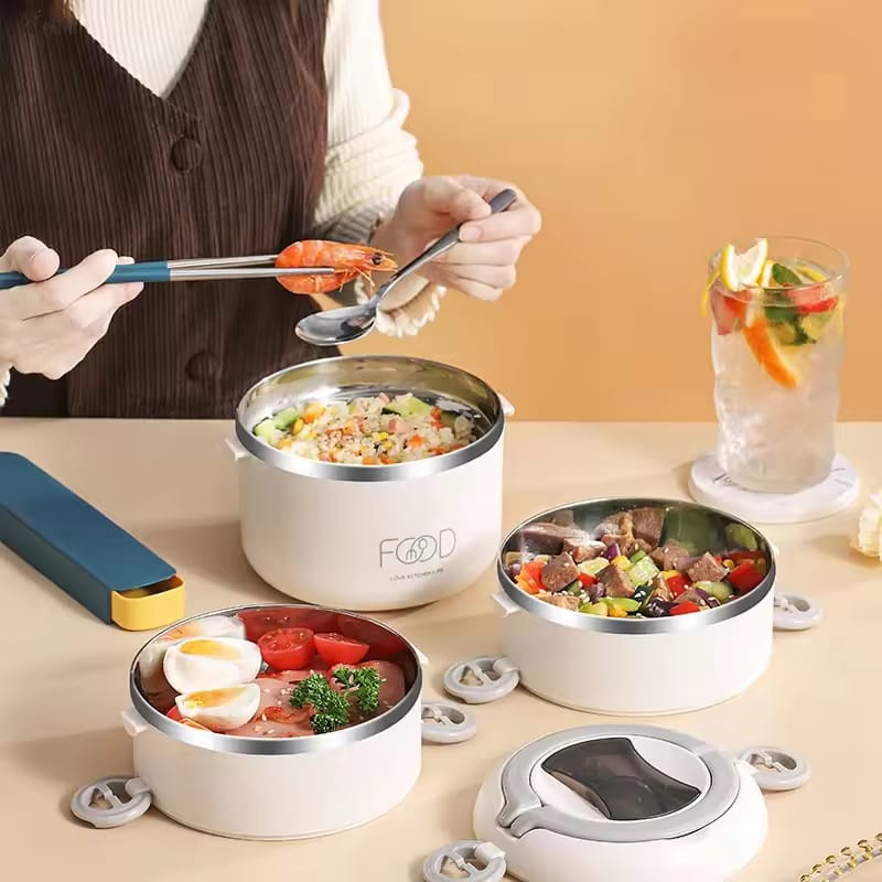 A Women is Filling a Multi-layer Thermal Insulated Lunch Box With Different Food Items.