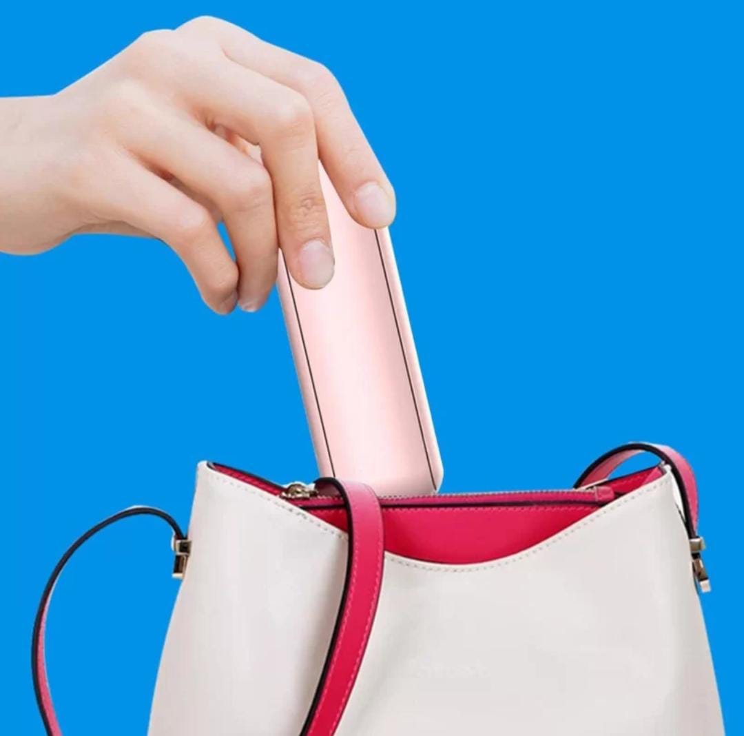 A Person is Keeping Multifunction Folding Mini Fan in Her Bag.