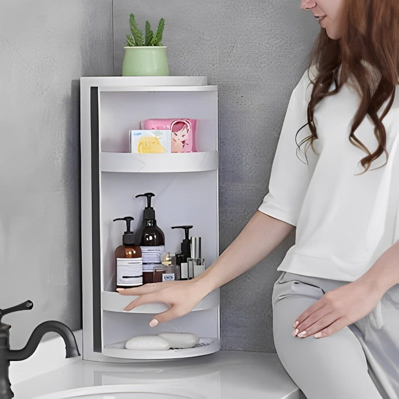 A lady arranging items in the 360° Rotating Bathroom Corner Storage Shelf