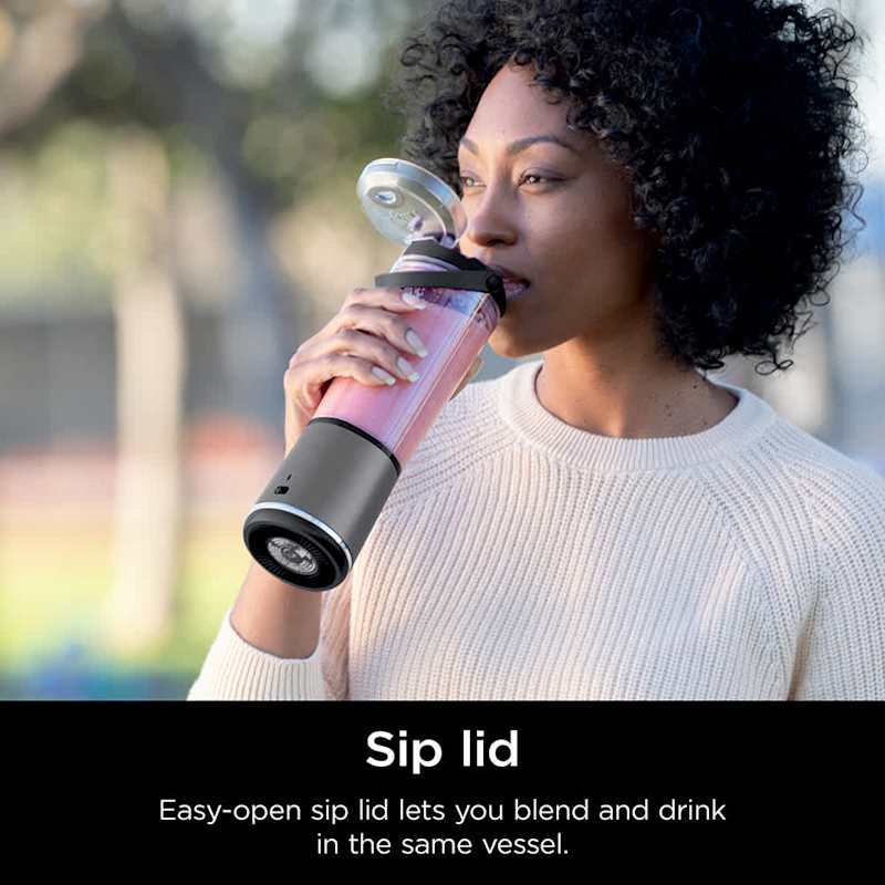 A Woman is Drinking From Ninja Blast Portable Blender.