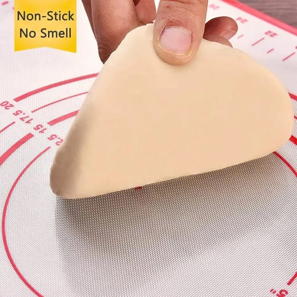 A Person is Rolling Dough in a Non-Slip Baking Mat With Measurements.