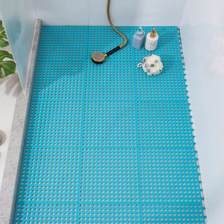 A Blue Non-Slip Bathroom Shower Mat is Placed at the Floor Of Shower Room.