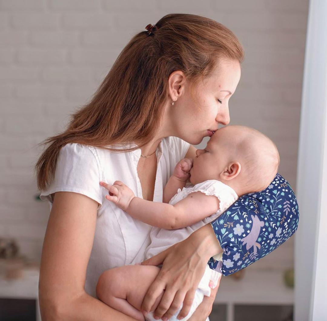 A Women is Holding Her Baby By Placing Nursing Arm Pillow On Her Hand.